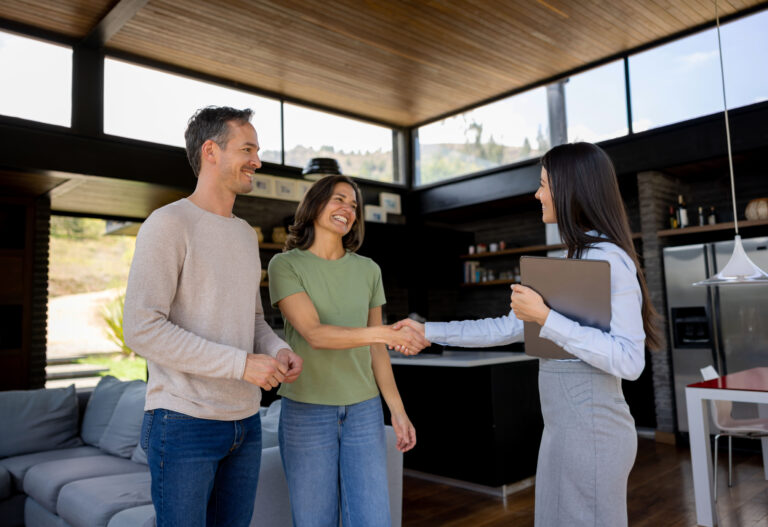 Homebuyers shaking hands with a real estate agent