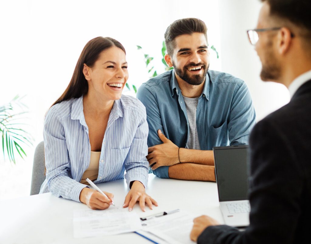 Couple completing mortgage loan documents